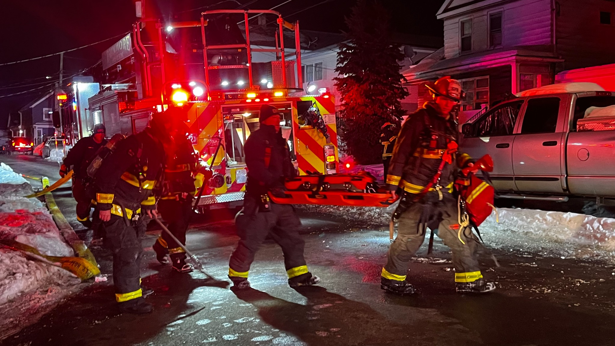 Firefighters at a night fire scene